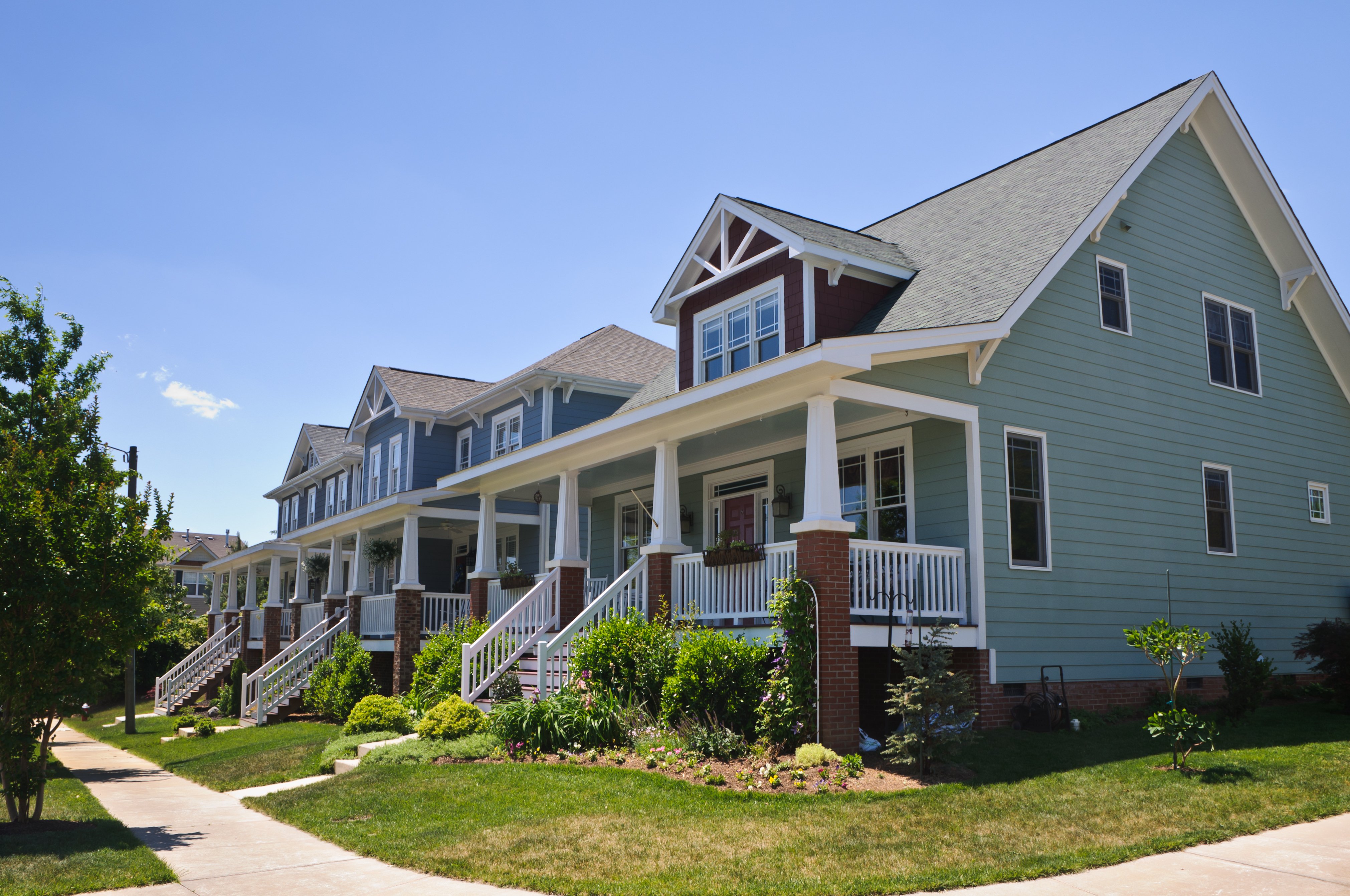 A row of similar single-family homes on a tree-lined street, the kind of comparable properties an agent uses in a CMA