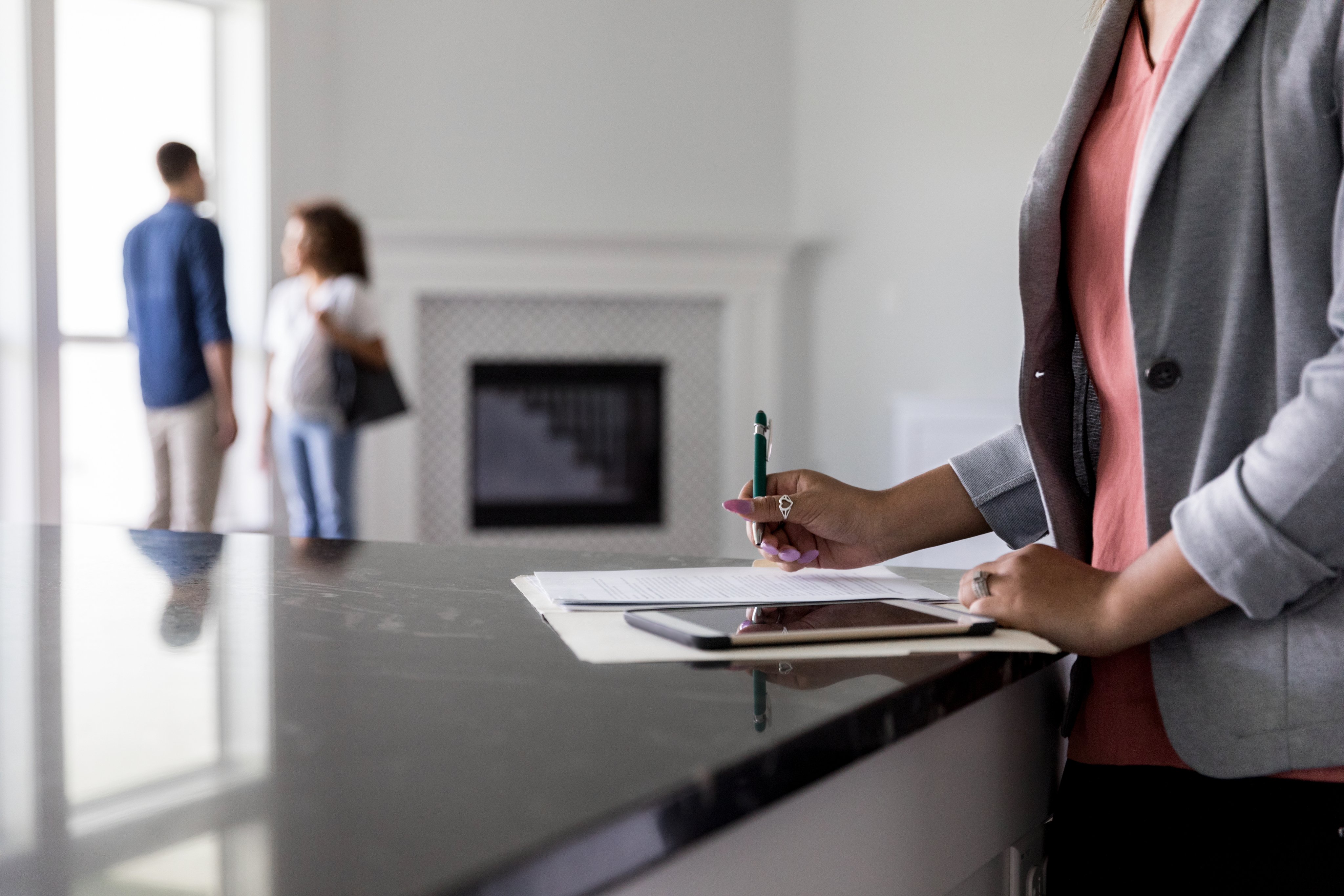 Real estate agent reviewing paperwork and calculations at a desk