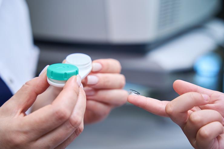 an optometrist fitting contact lenses