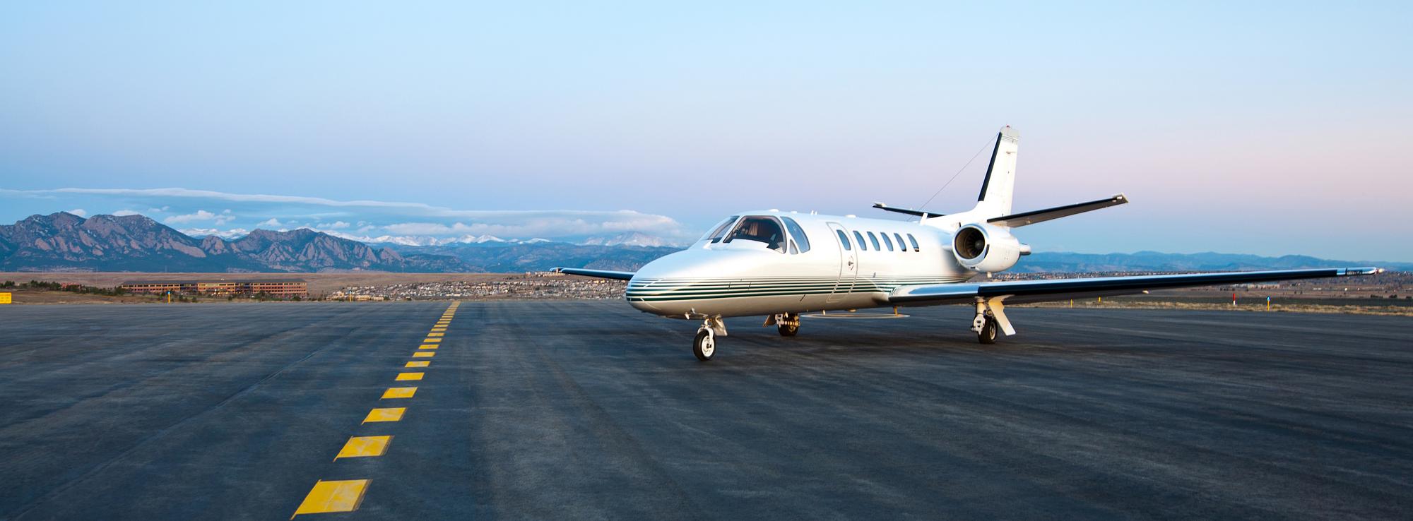 Private jet parked at a mountain airport ramp where runway length limits access