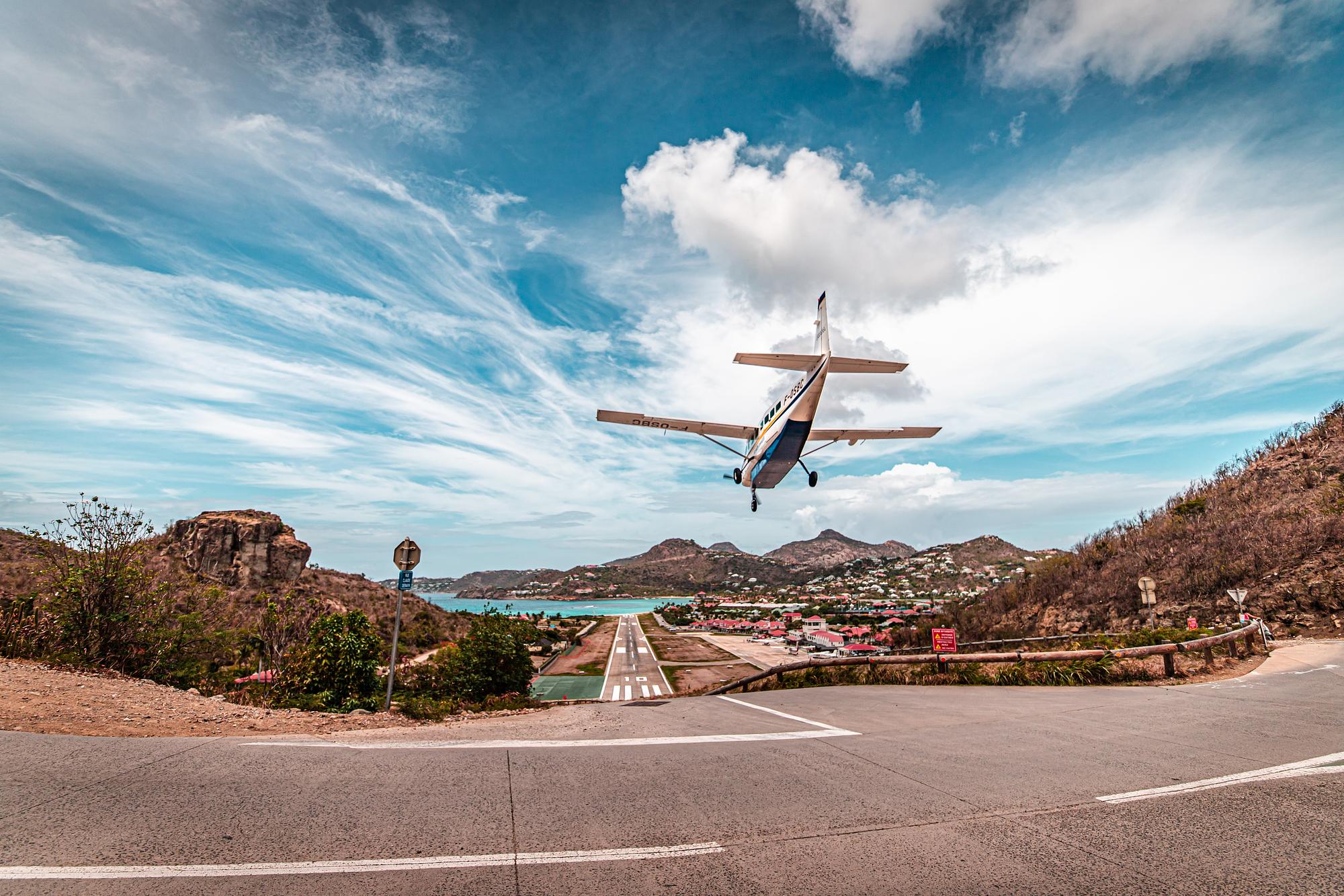 Private jet on final approach to a short island runway with restricted access