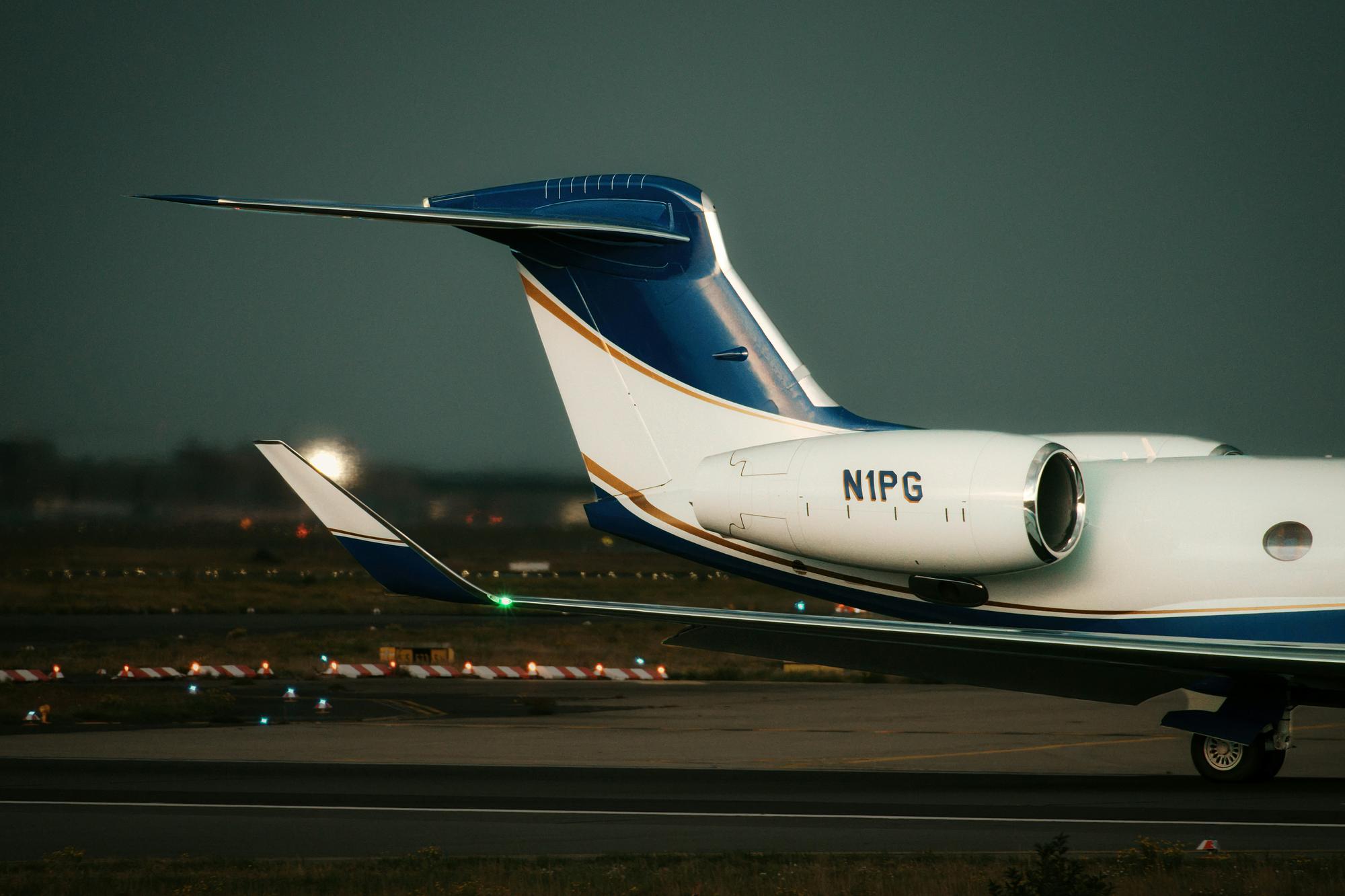 Ultra-long-range private jet on the tarmac at dusk – Gulfstream G650 private jet charter