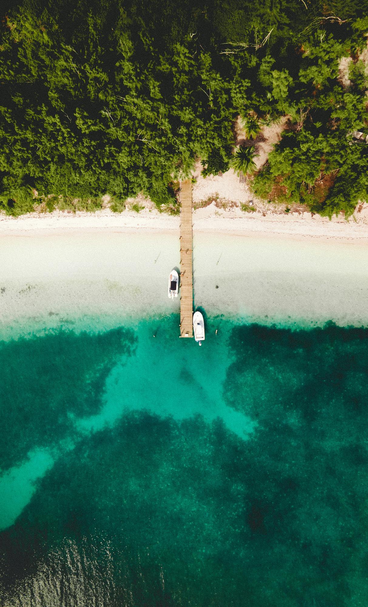 Aerial view of a turquoise Bahamas beach, a warm-weather spring break destination for families