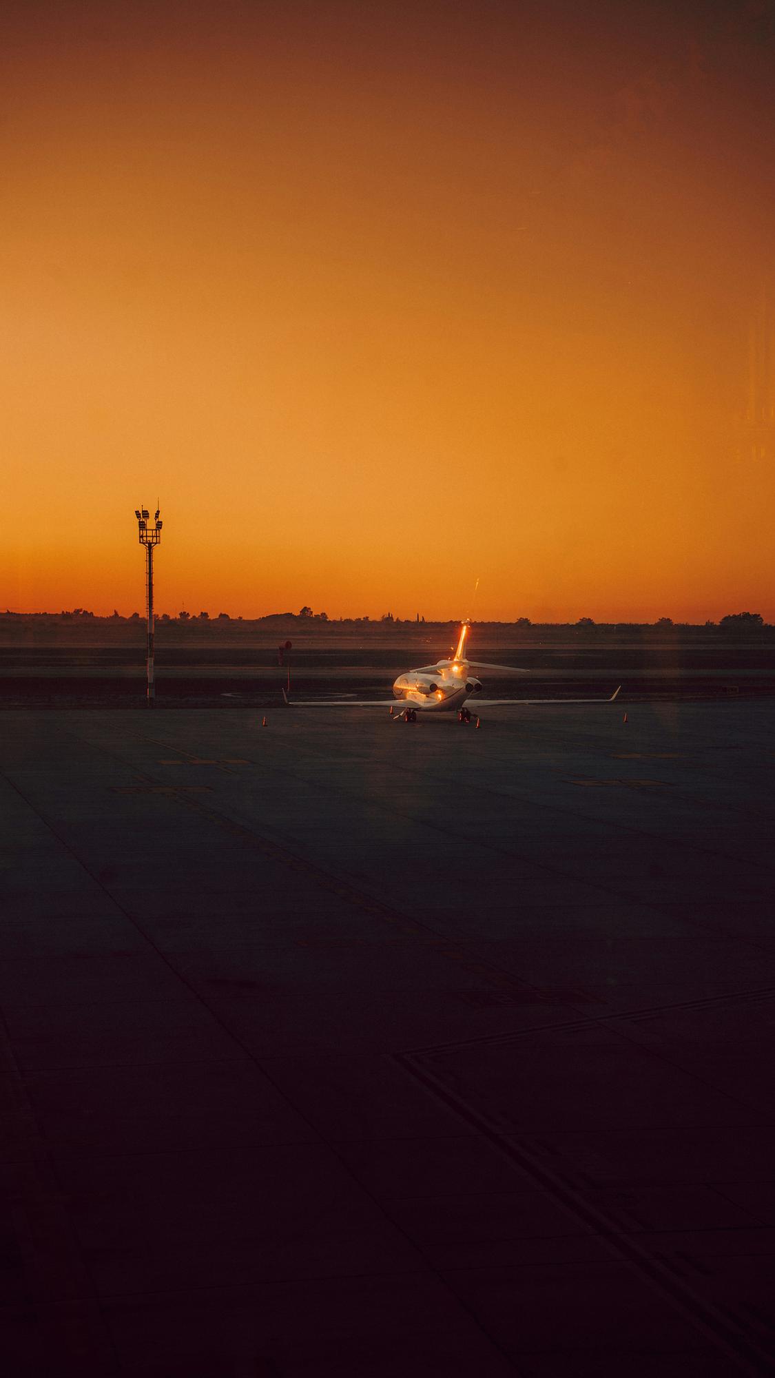 Embraer Legacy 650E heavy private jet on the tarmac at sunset