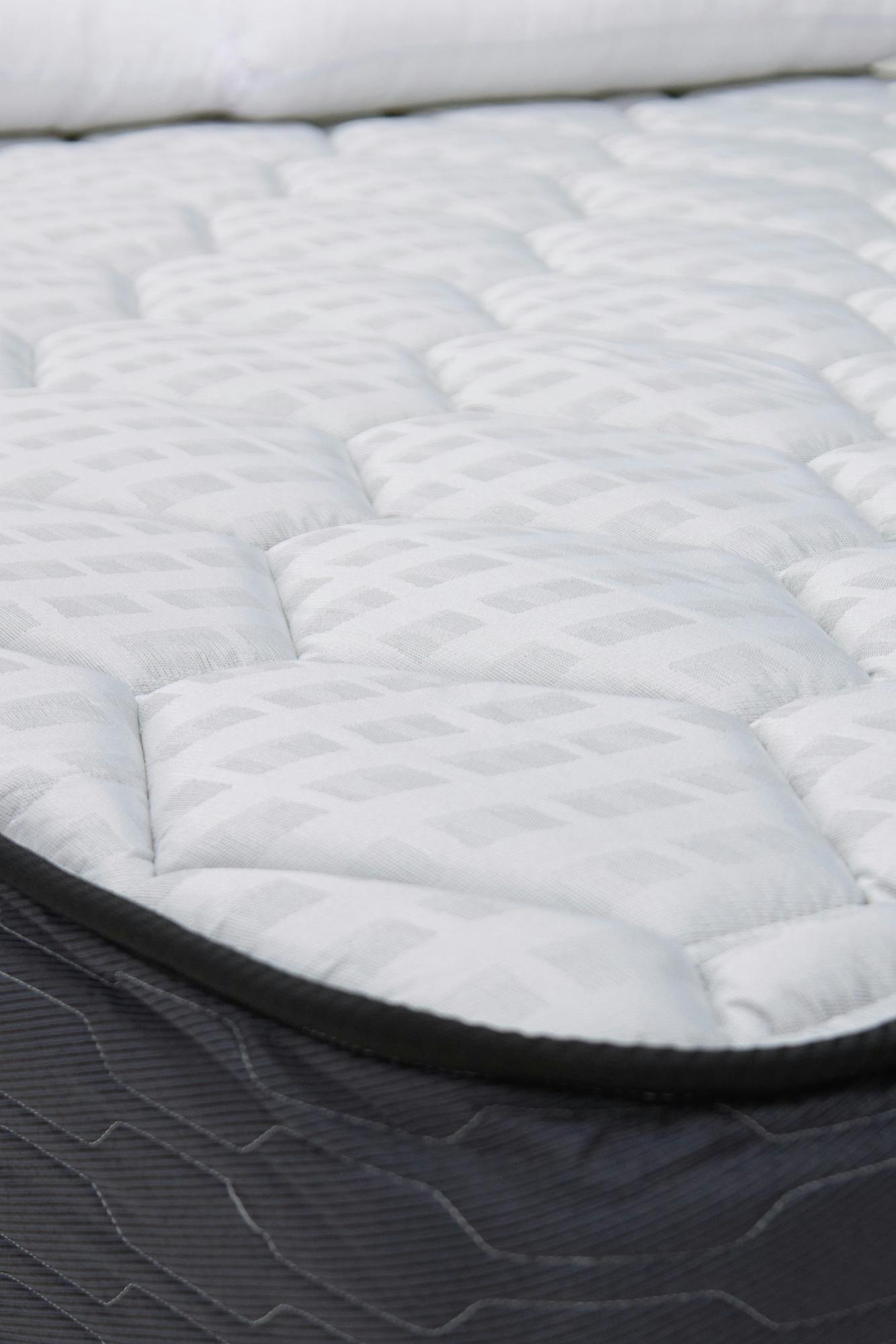 Close-up of a mattress seam and corner where bed bugs hide during a furniture inspection