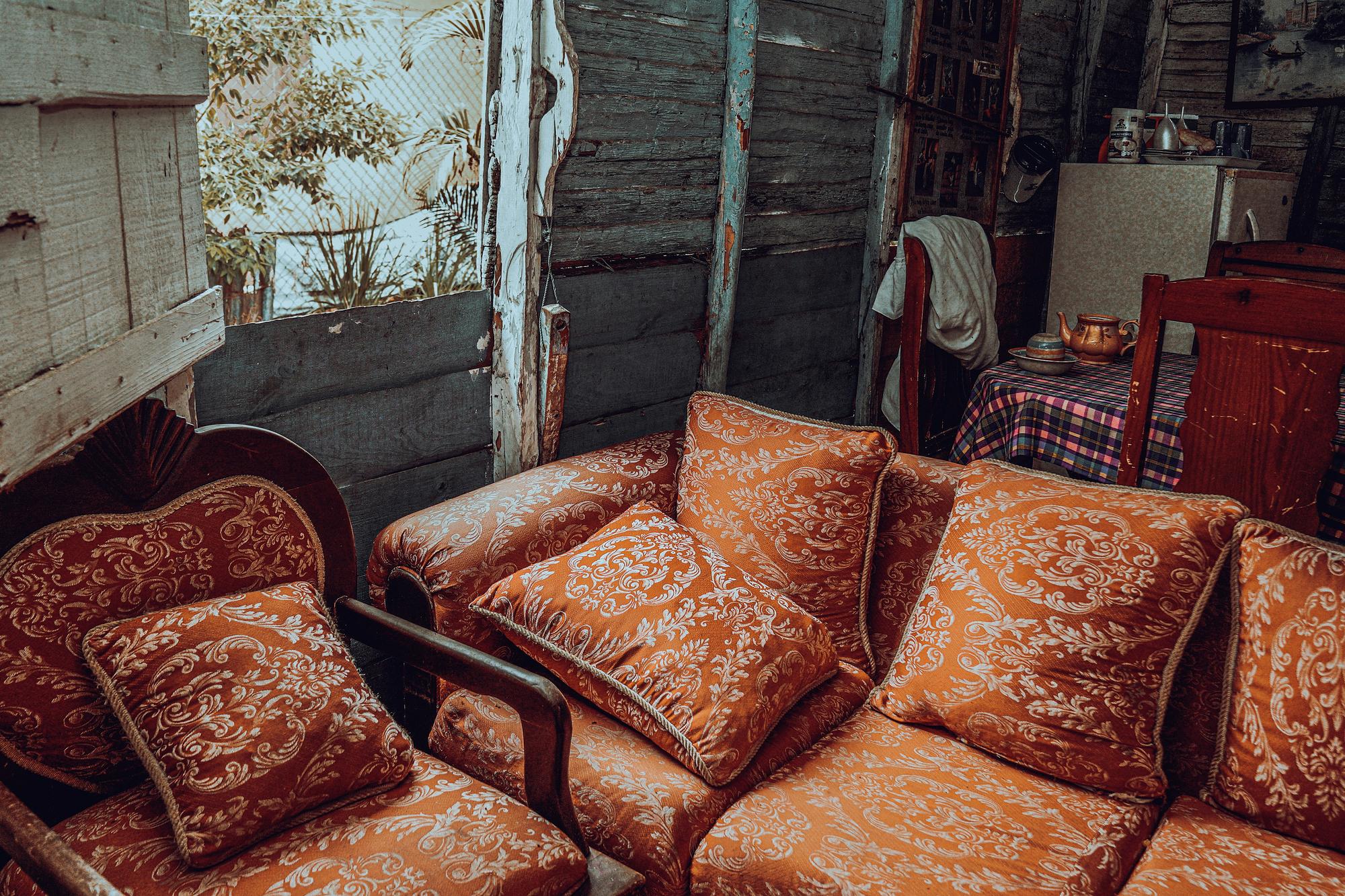 Secondhand sofas and armchairs for sale on a sidewalk, a common source of bed bugs