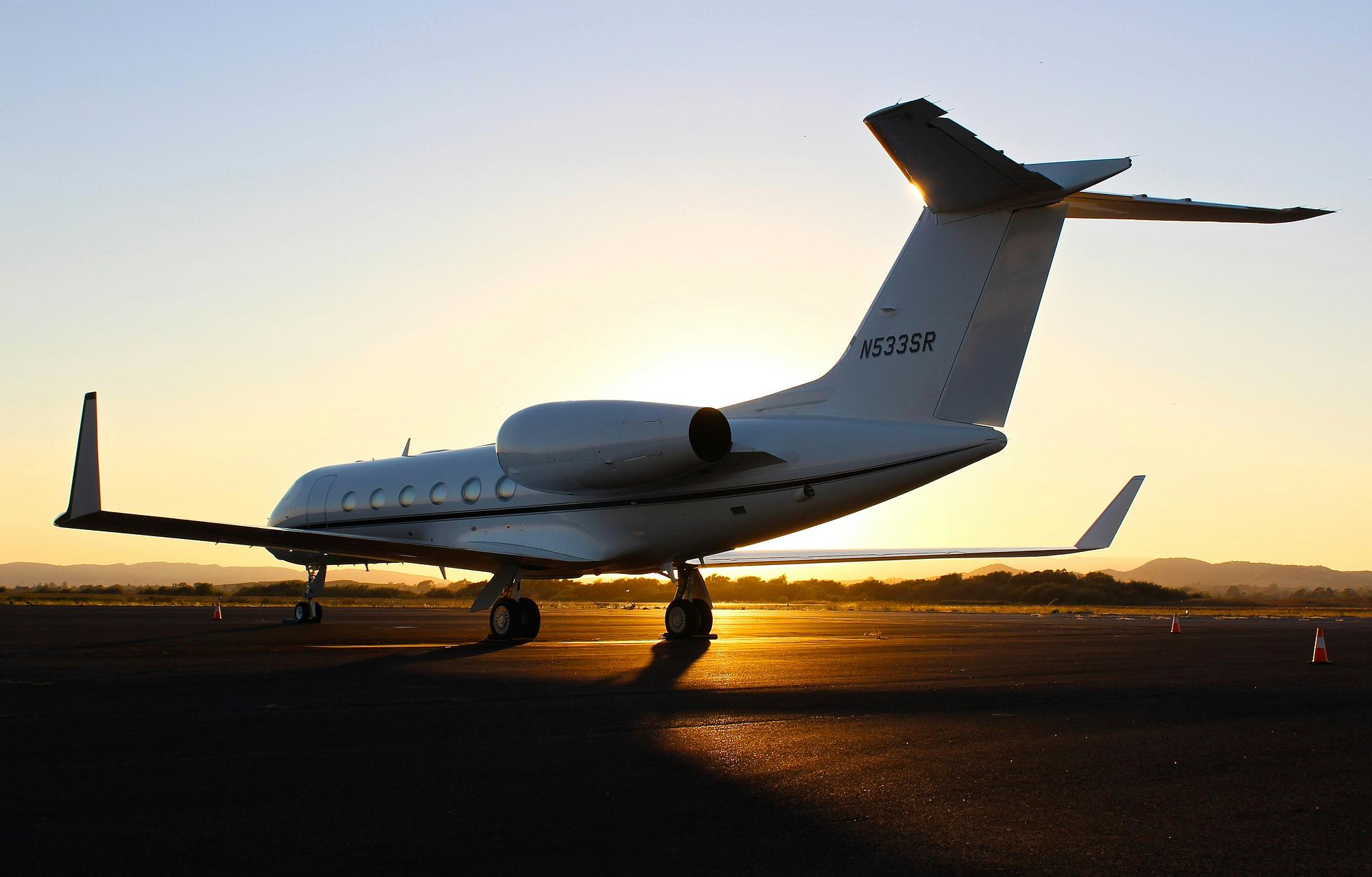 Private jet on the tarmac at golden hour before a Kentucky Derby journey to Louisville