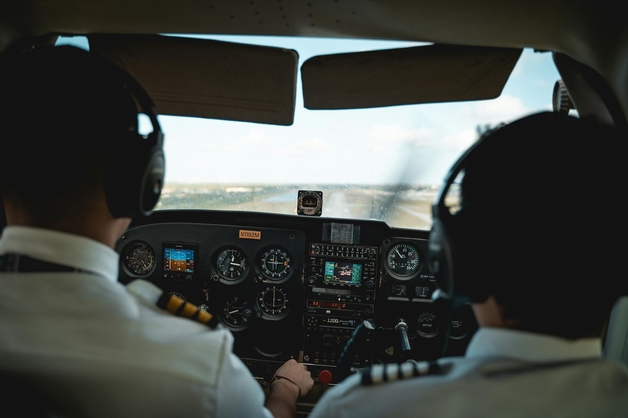 Two pilots run preflight checks in the cockpit, the crew currency a WYVERN PASS report verifies